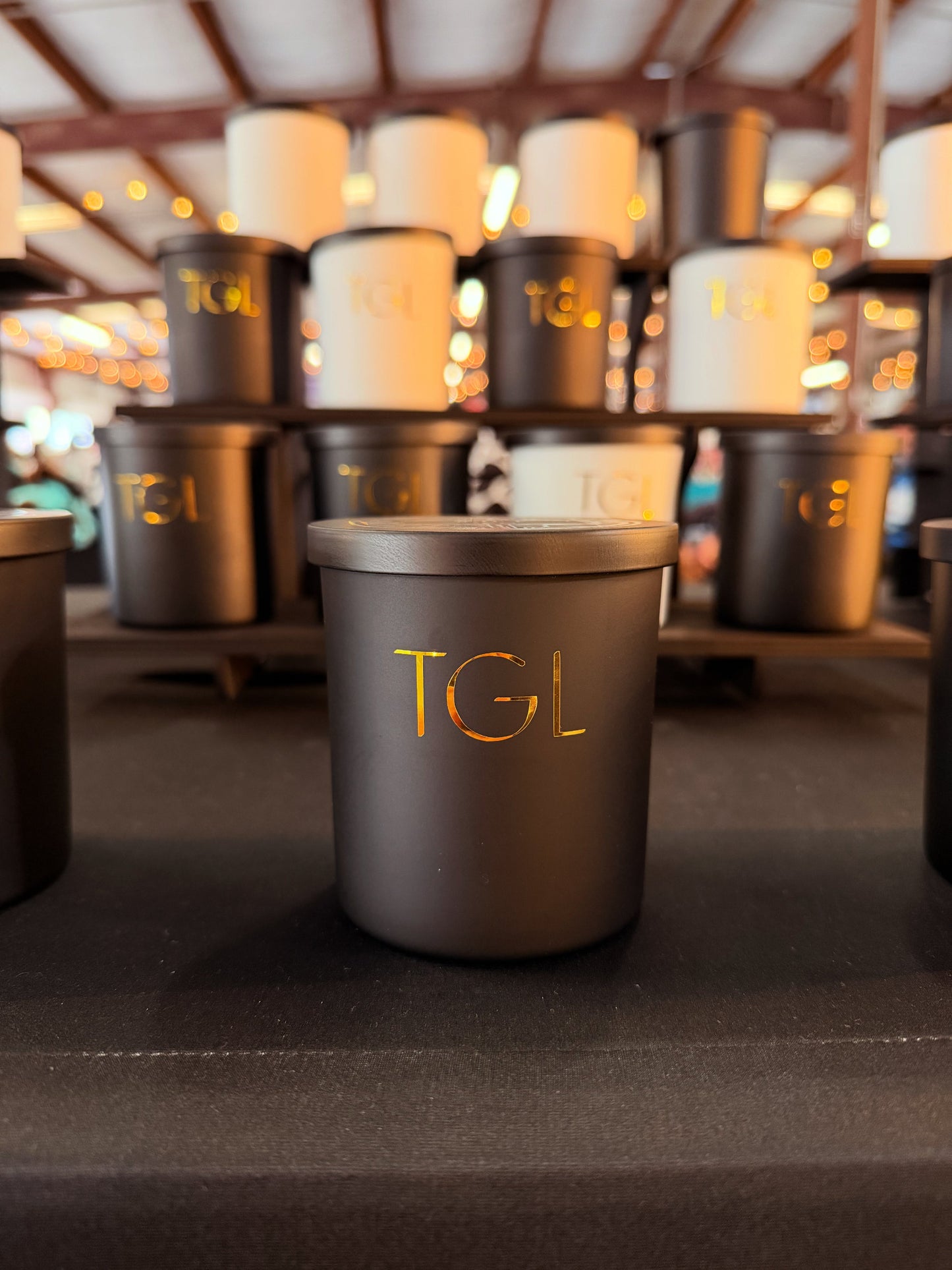 Dark containers with 'TGL' branding on a blurred background