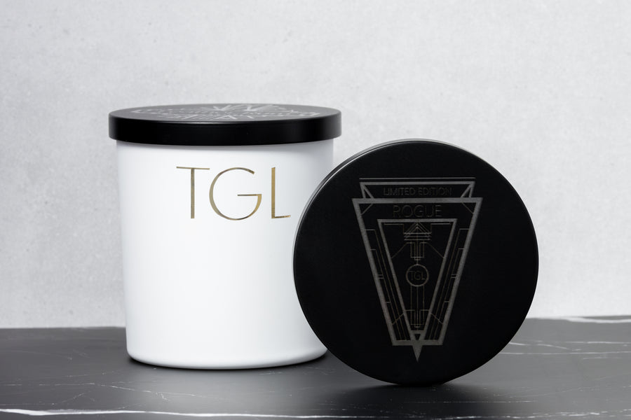 White TGL jar beside its black engraved lid