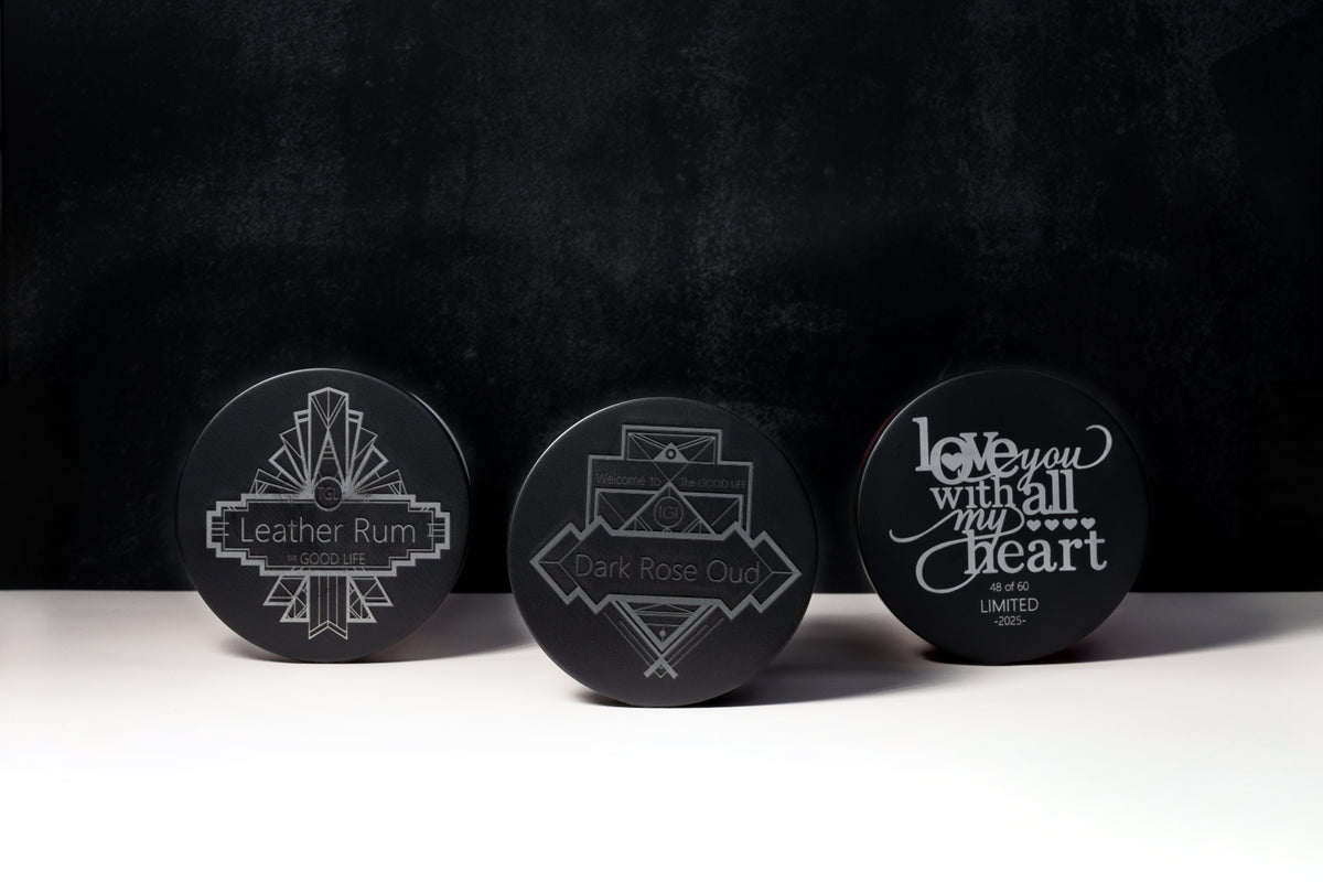 Three black TGL candle lids engraved with Art Deco designs