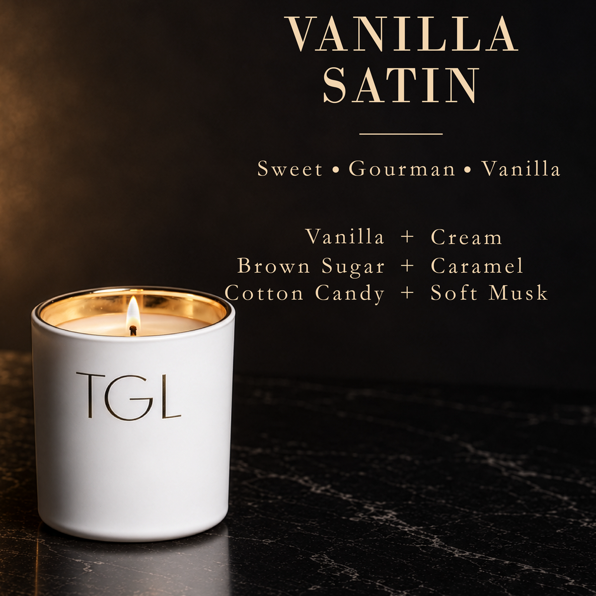 A white ceramic candle jar with a gold-toned inner rim and a lit wick, labeled 'TGL' on the front. The candle is set on a dark marble surface against a dark background with elegant gold text reading 'VANILLA SATIN' and scent notes including vanilla, cream, brown sugar, caramel, cotton candy, and soft musk.