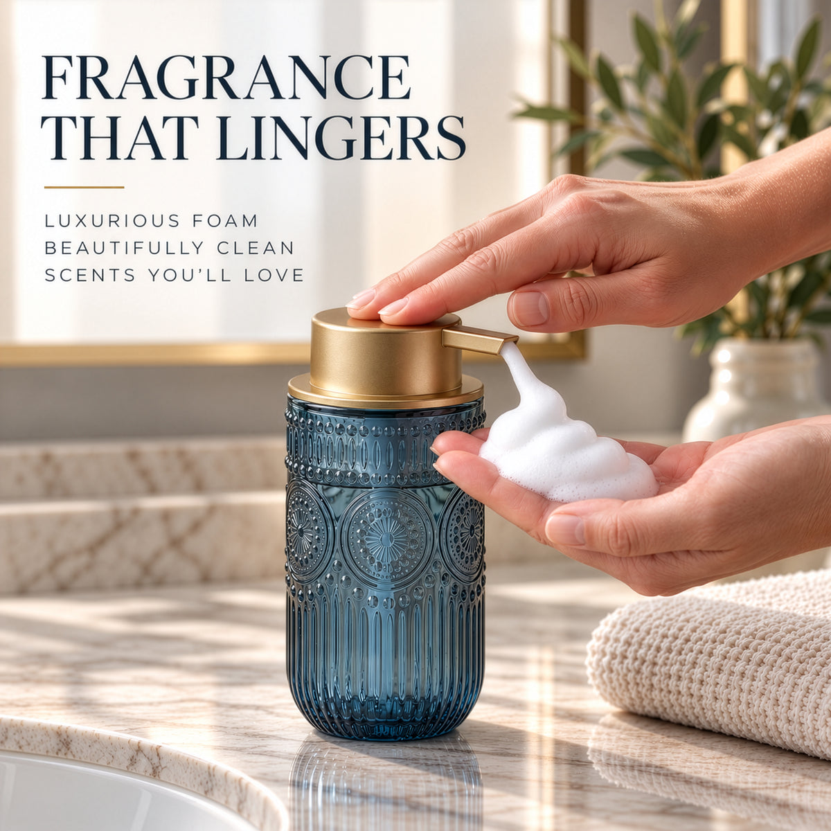 Hand pumping foam from a blue embossed glass soap dispenser with a gold pump