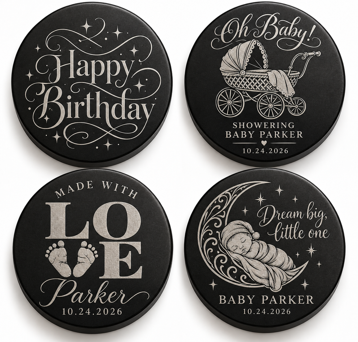 Four black candle lids engraved with baby shower designs, shown together