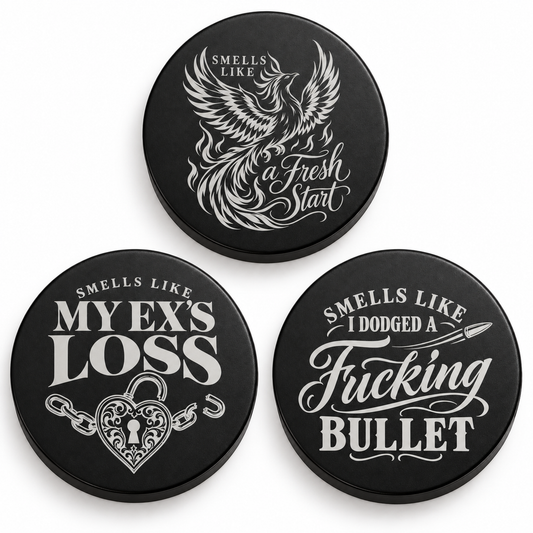 Three black candle lids engraved with break up designs, shown together